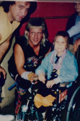 Wish kid Benny posing with The Rock N Roll Express on his wish